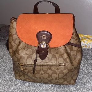 Brown tie Coach book bag with orange fold over.